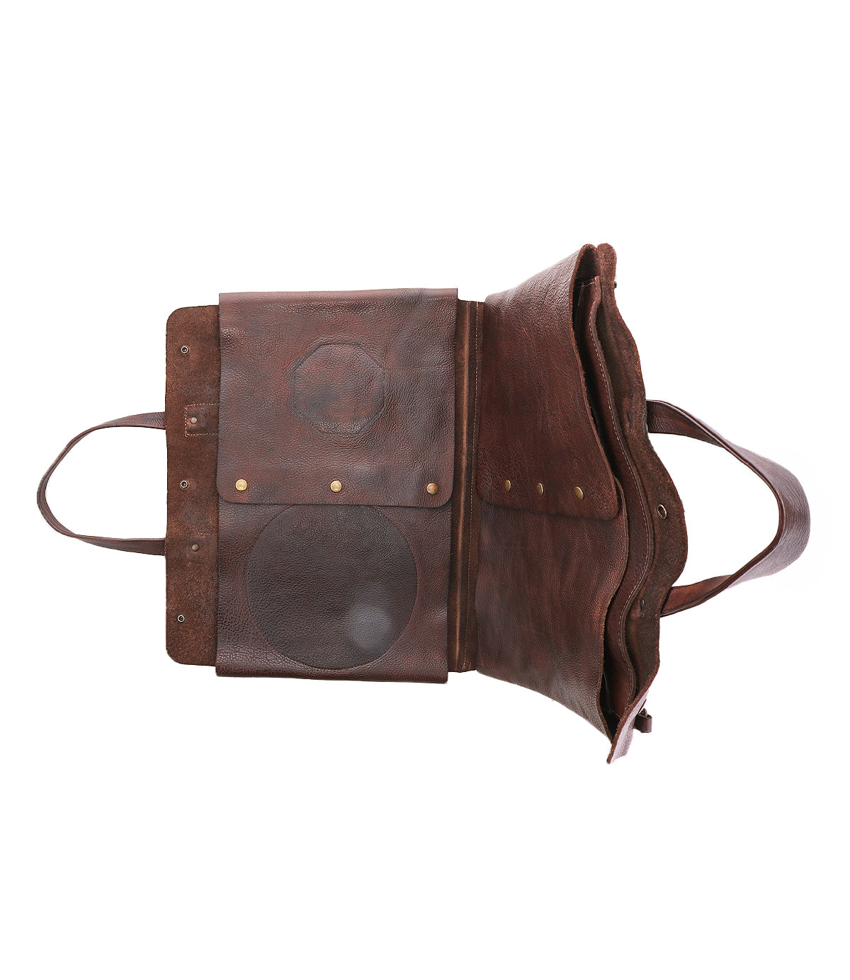 The Bed Stu Commuter is a brown leather satchel featuring two circular patches, brass rivets, two handles, a flap, and pocket—designed as a multifunctional bag with ample storage for your laptop.