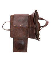 The Bed Stu Commuter is an open brown leather accessory briefcase, shown from above to highlight its multifunctional compartments, flaps, and dedicated laptop storage.