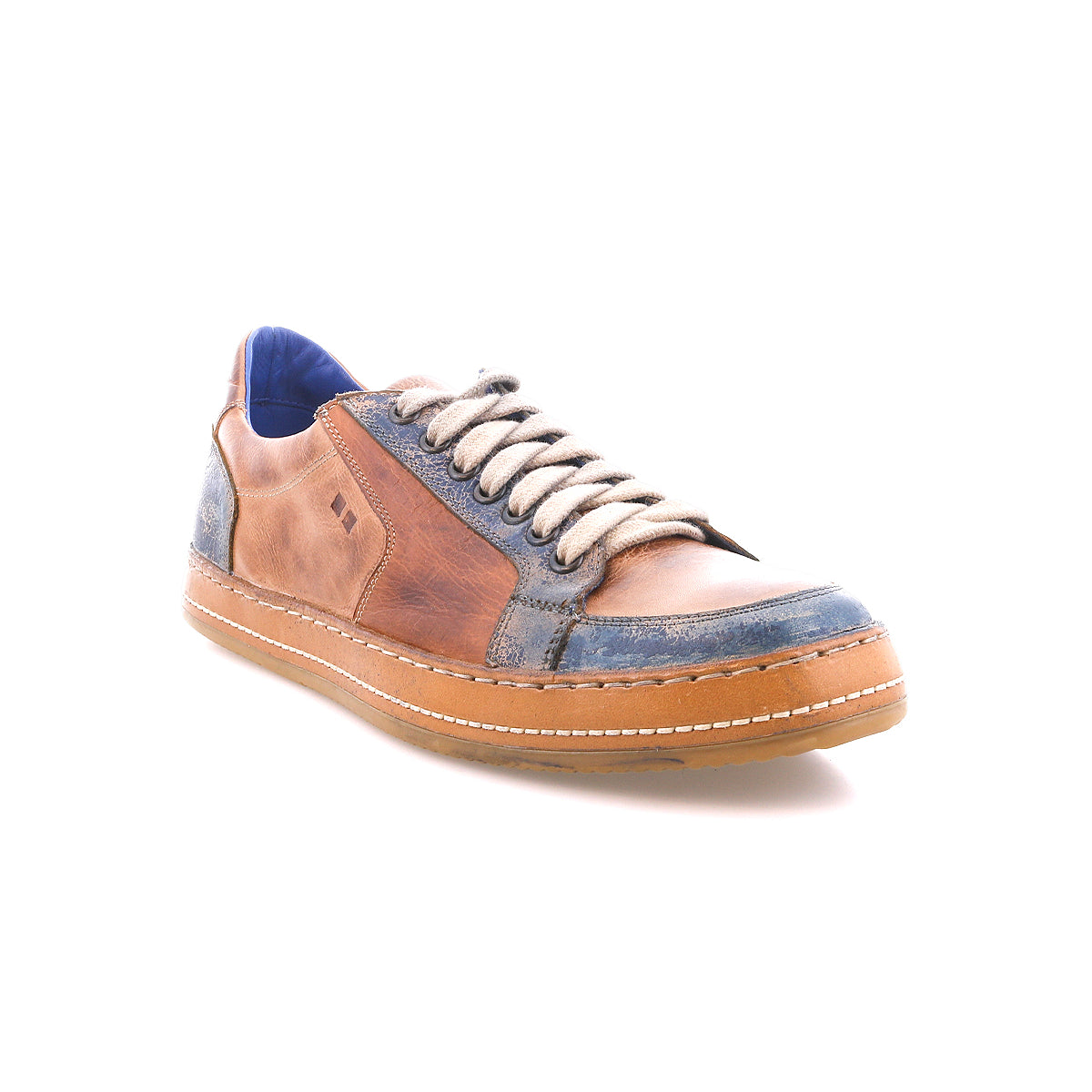 The Bed Stu Condor sneaker features brown and blue leather, durable construction, white laces, a blue interior lining, and a tan rubber sole. Shown at a three-quarter angle on a white background.