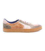The Bed Stu Condor is a comfortable, low-top leather sneaker in tan, beige, and olive green with a durable build, rubber sole, blue interior lining, and is shown in side profile.