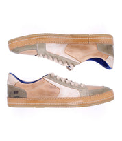 The Bed Stu Condor sneakers feature comfortable beige and light brown leather uppers with rubber soles, shown in a side view against a white background.