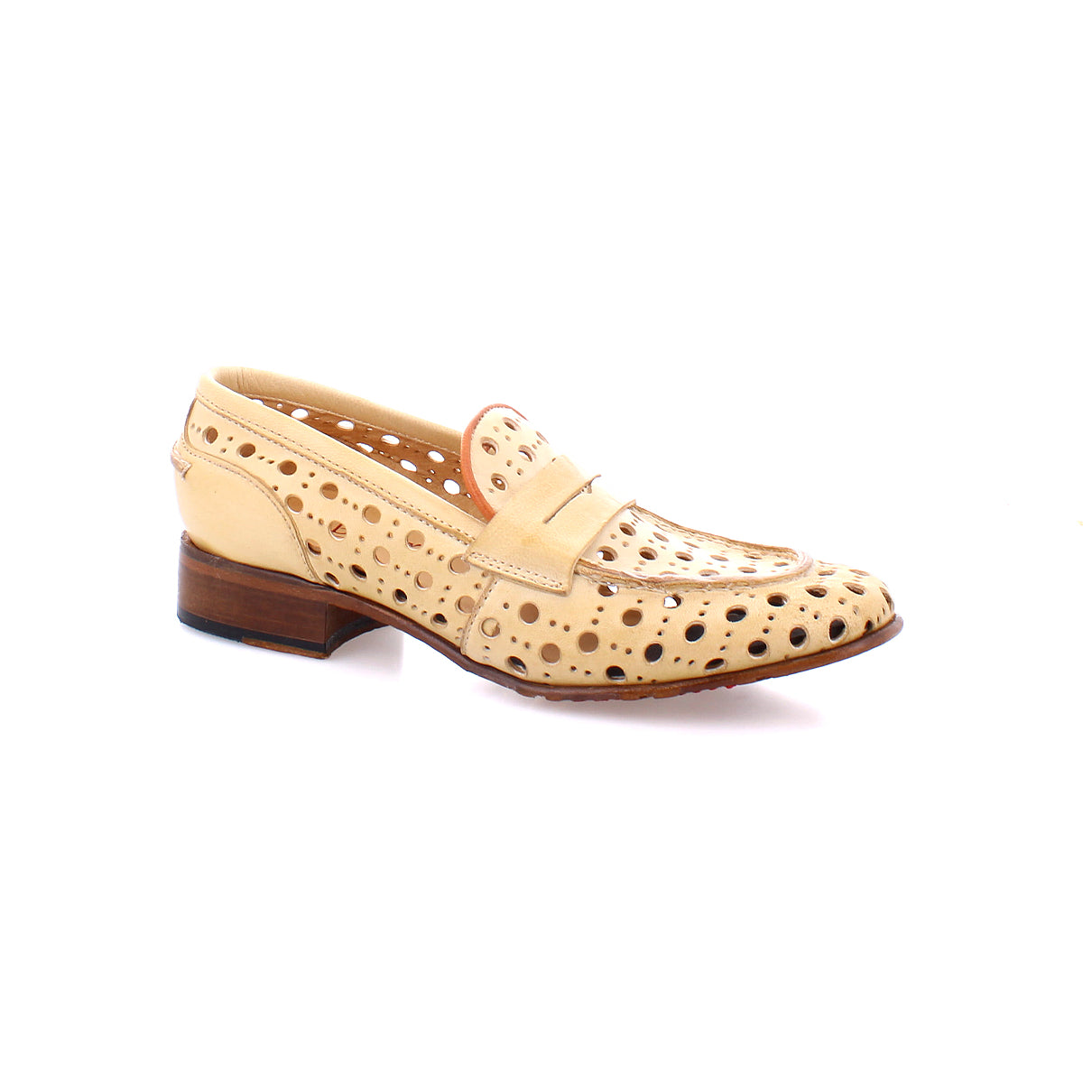 A beige handcrafted penny loafer made of perforated leather, featuring a playful circular cutout pattern and a low wooden heel, the Cornflower by Bed Stu.
