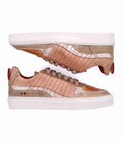 A pair of Bed|Stü Cosmo sneakers in brown and beige leather, featuring red contrast stitching, white outsoles, and a textured upper in a classic silhouette, shown from the side and bottom against a white background.