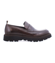 The Bed Stu Costruito, an Italian-made penny loafer in brown leather, features a chunky black sole and exudes artisanal charm from its side view.