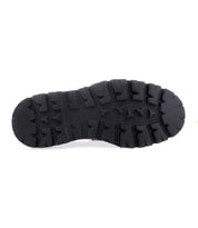The image displays the sole of the Costruito penny loafer by Bed Stu, featuring a rugged, textured tread pattern designed for traction, and crafted in Italy.