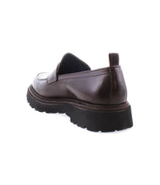 The Costruito by Bed Stu is a brown leather loafer with a chunky black sole, viewed from the back, highlighting its Italian-made penny loafer elegance and artisanal charm.
