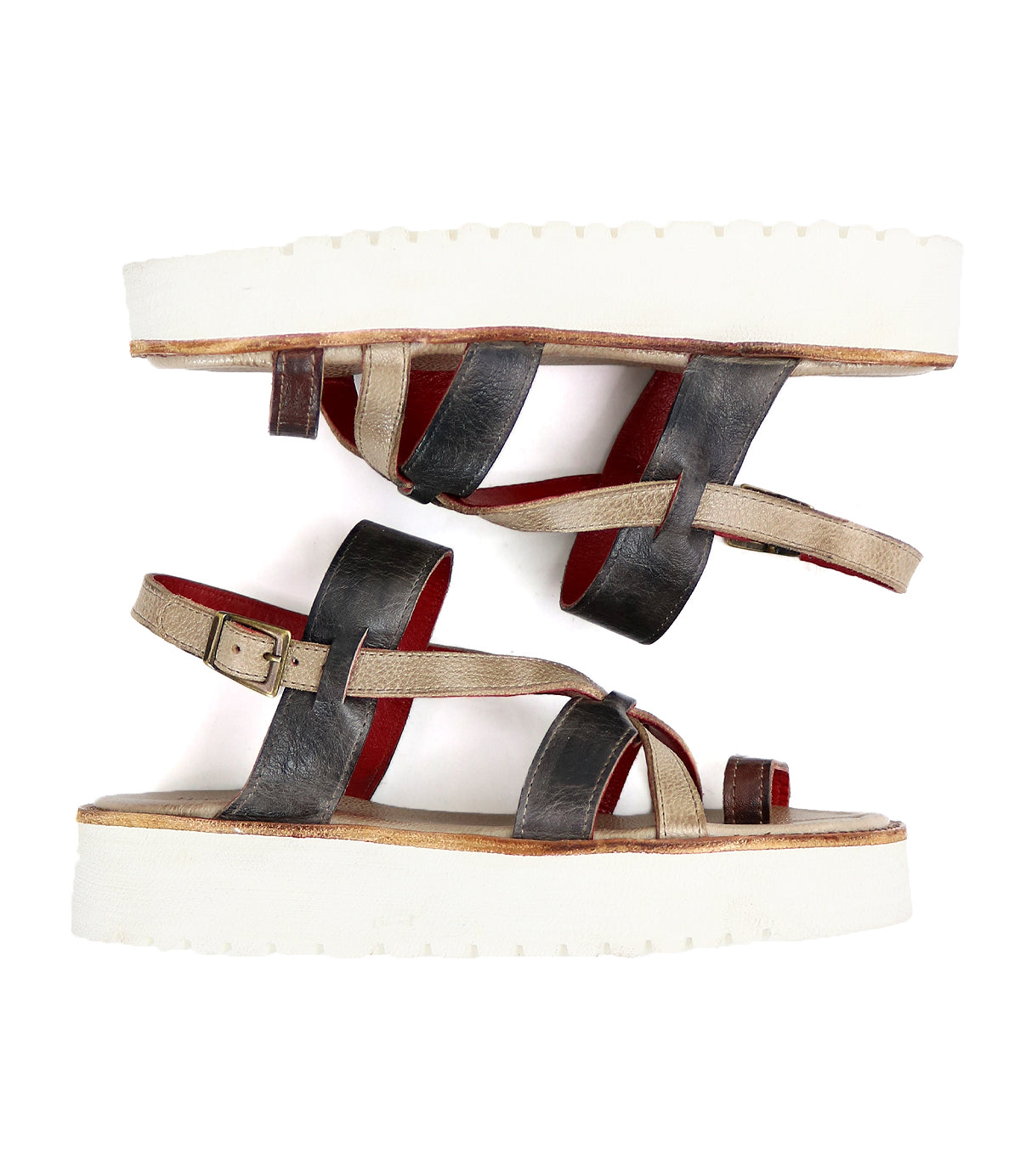 A pair of Bed Stu women's multicolor strappy sandals with white soles.