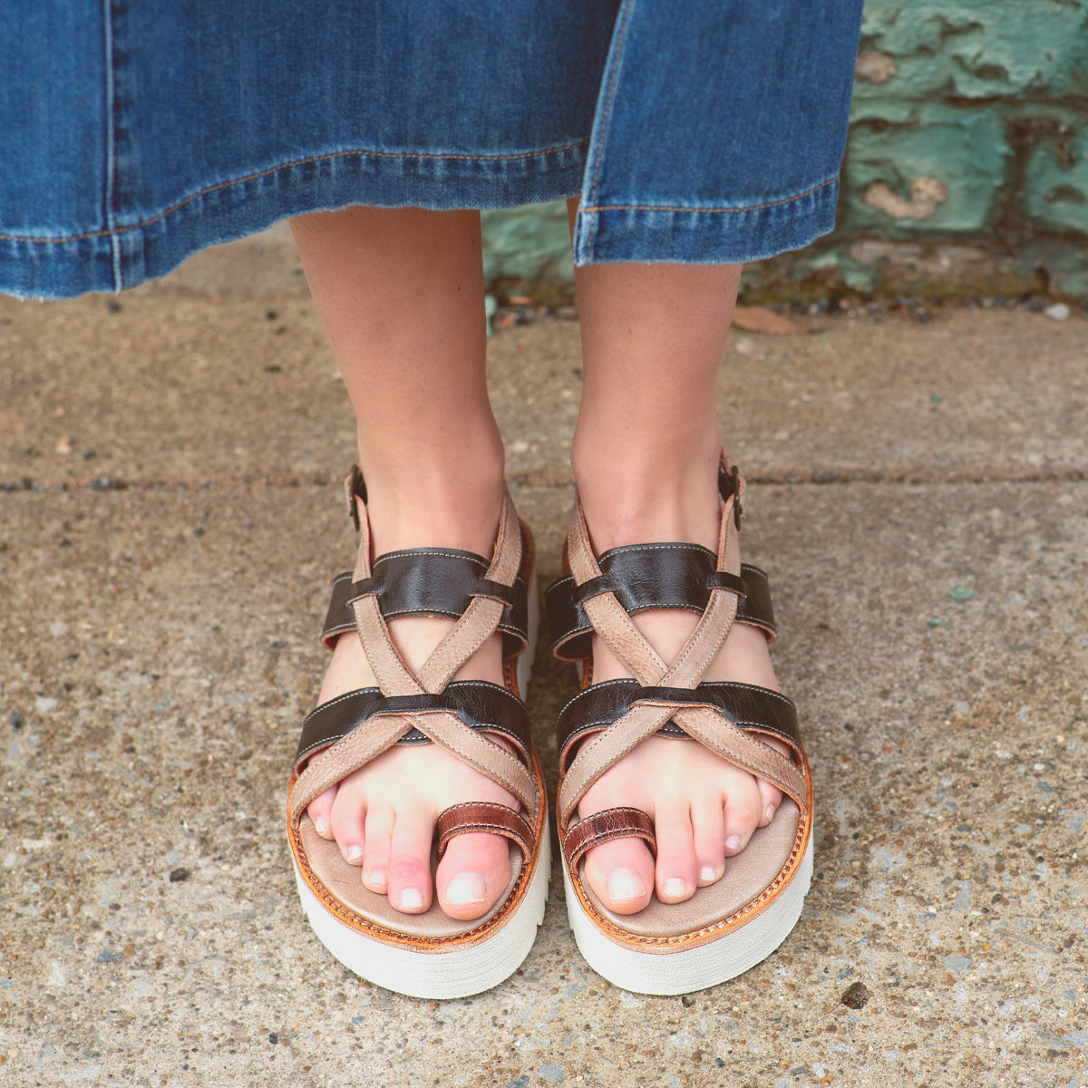 A woman wearing Bed Stu sandals with a strappy upper.