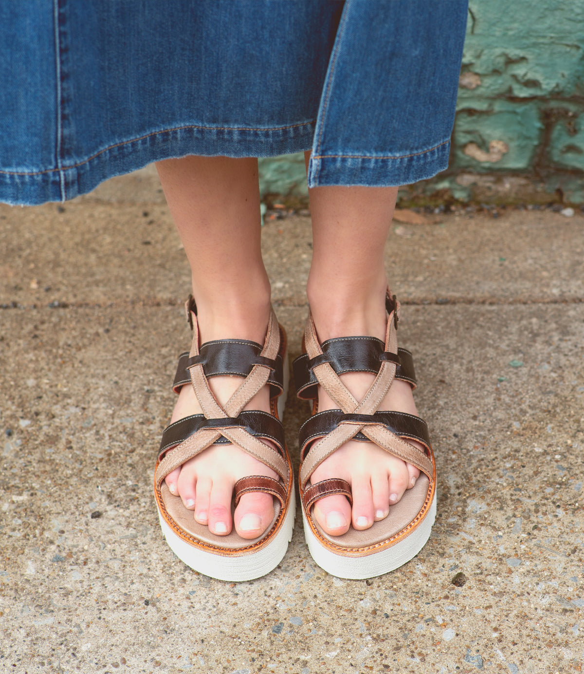 A woman wearing Bed Stu sandals with a strappy upper.