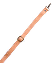 The Bed Stu Crossbody Strap is a tan adjustable leather strap with a metal buckle and slider, ideal for Bed Stu bags or as a replacement crossbody strap, shown against a white background.