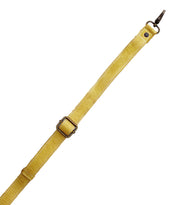 A yellow adjustable leather Crossbody Strap by Bed Stu with metal buckle and clasp, shown diagonally on a white background—perfect for matching with Bed Stu bags.