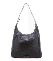 The Bed|Stü Dallas LTC is a black leather shoulder bag featuring a single strap, zippered top, and front pocket accents, designed as a stylish concealed carry bag and displayed against a white background.