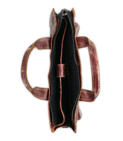 Top view of the Bed Stu Depp: a minimalist brown leather work bag with two handles, featuring a spacious main compartment and inner pocket, all lined with sleek black fabric.