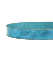 A close-up of the Bed Stu Dreampath genuine leather belt in blue, showcasing visible stitching, multiple adjustment holes, and an octagon metal buckle.