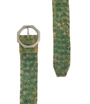 Close-up of the Bed Stu Dreamweaver, a green woven vintage boho belt with a statement octagonal silver buckle, showing both the buckle end and the pointed tip.