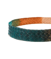 The Bed Stu Dreamweaver belt showcases a woven dark green exterior, light brown interior, and a bold metal buckle in a stylish vintage boho design.