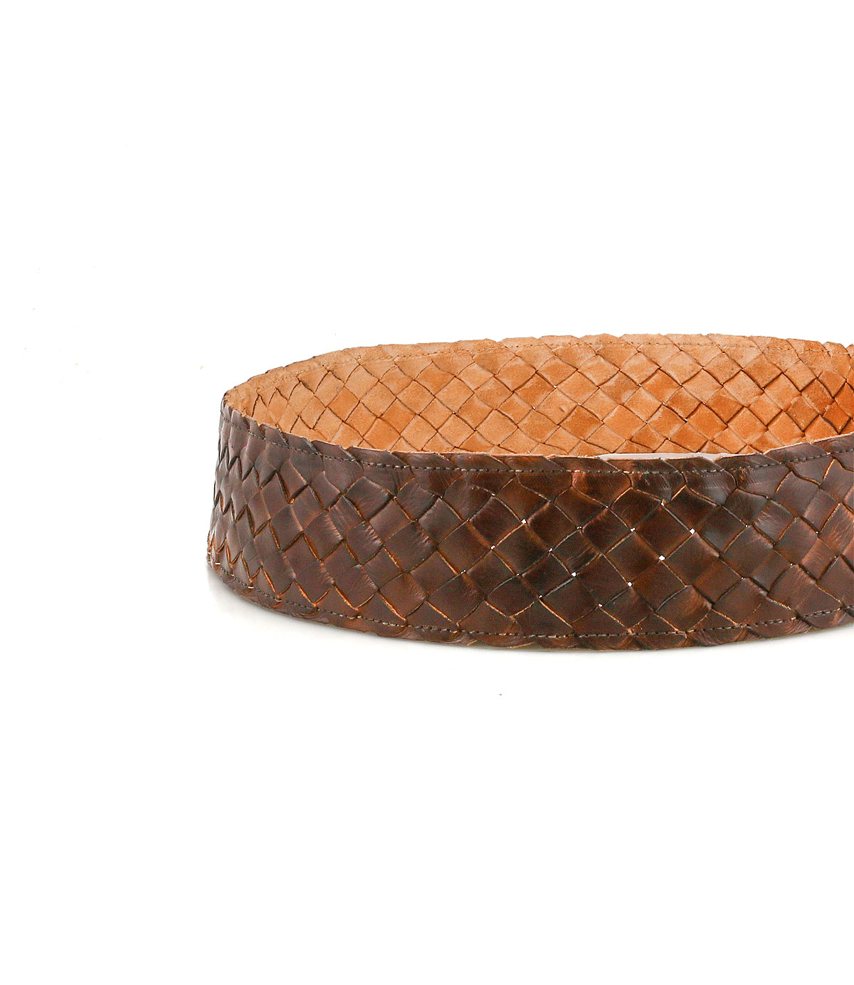 The Bed Stu Dreamweaver is a round, shallow basket of tightly woven brown strips and a smooth, flat tan interior—perfect for adding vintage boho charm to any room. No visible handles.