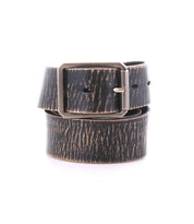The Bed|Stü Drifter is a black and brown distressed leather belt with a rectangular metal buckle and a textured leather strap, shown coiled against a white background.