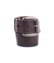 The Bed Stu Drifter, a rolled-up dark brown leather belt with a silver buckle shown on a white background, is the ideal weekend accessory for a dapper touch.