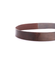 The Drifter by Bed Stu is a plain brown leather belt without a buckle, styled in a circle on a white background—perfect for adding effortless dapper appeal to your weekend look.