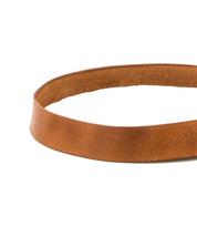 The Bed Stu Drifter belt, featuring a plain brown leather strap, is displayed in a circular shape on a white background—a stylish weekend accessory.