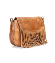 The Bed Stu Eastend is a stylish brown leather crossbody bag featuring fringe along the bottom, a flap closure, and metal side hardware—an eye-catching, handmade bohemian accessory.