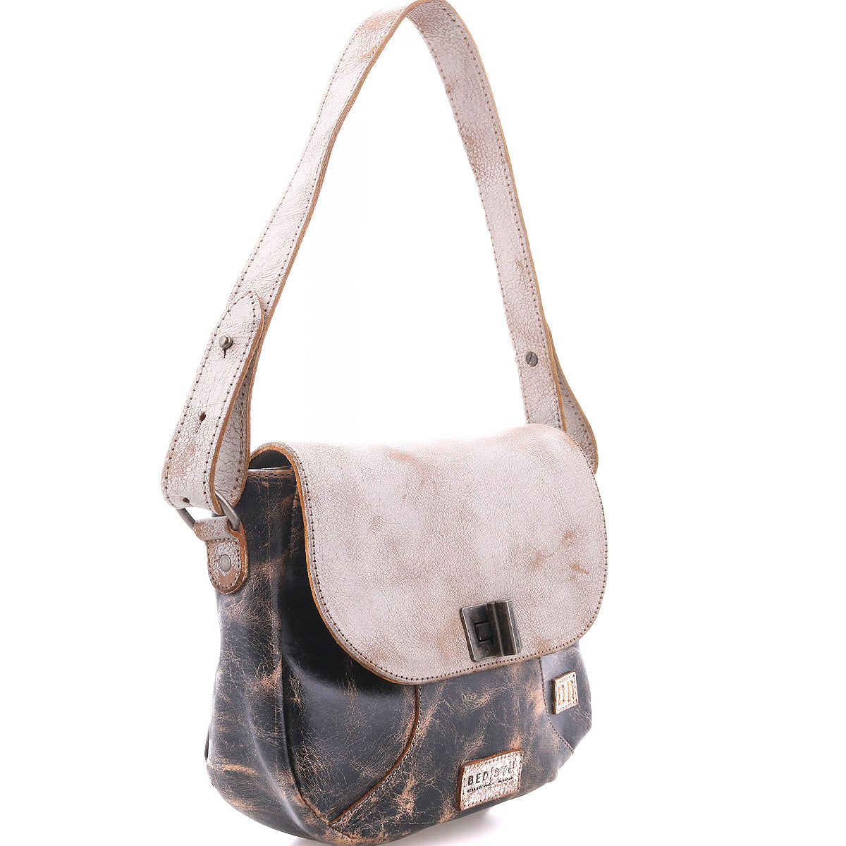 The Bed Stu Elect is a vintage-inspired shoulder bag featuring two-tone leather—a distressed dark brown body, light beige flap, adjustable strap, and buckle closure—displayed on a white background.