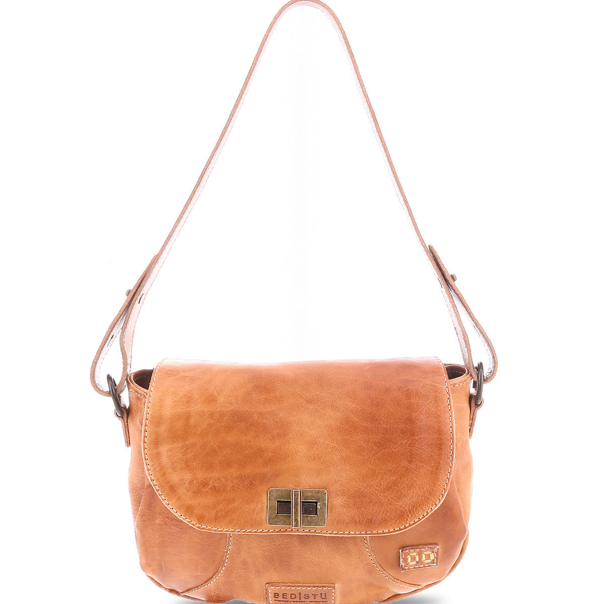 The Elect by Bed Stu is a chic tan leather shoulder bag with vintage charm, featuring a flap closure and adjustable shoulder strap. The front showcases a decorative buckle and subtle logo tag.