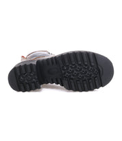 The image shows the bottom view of the Bed|Stü Elisha Hi boot in black, highlighting its textured rubber sole with deep treads and sturdy lace-up profile.