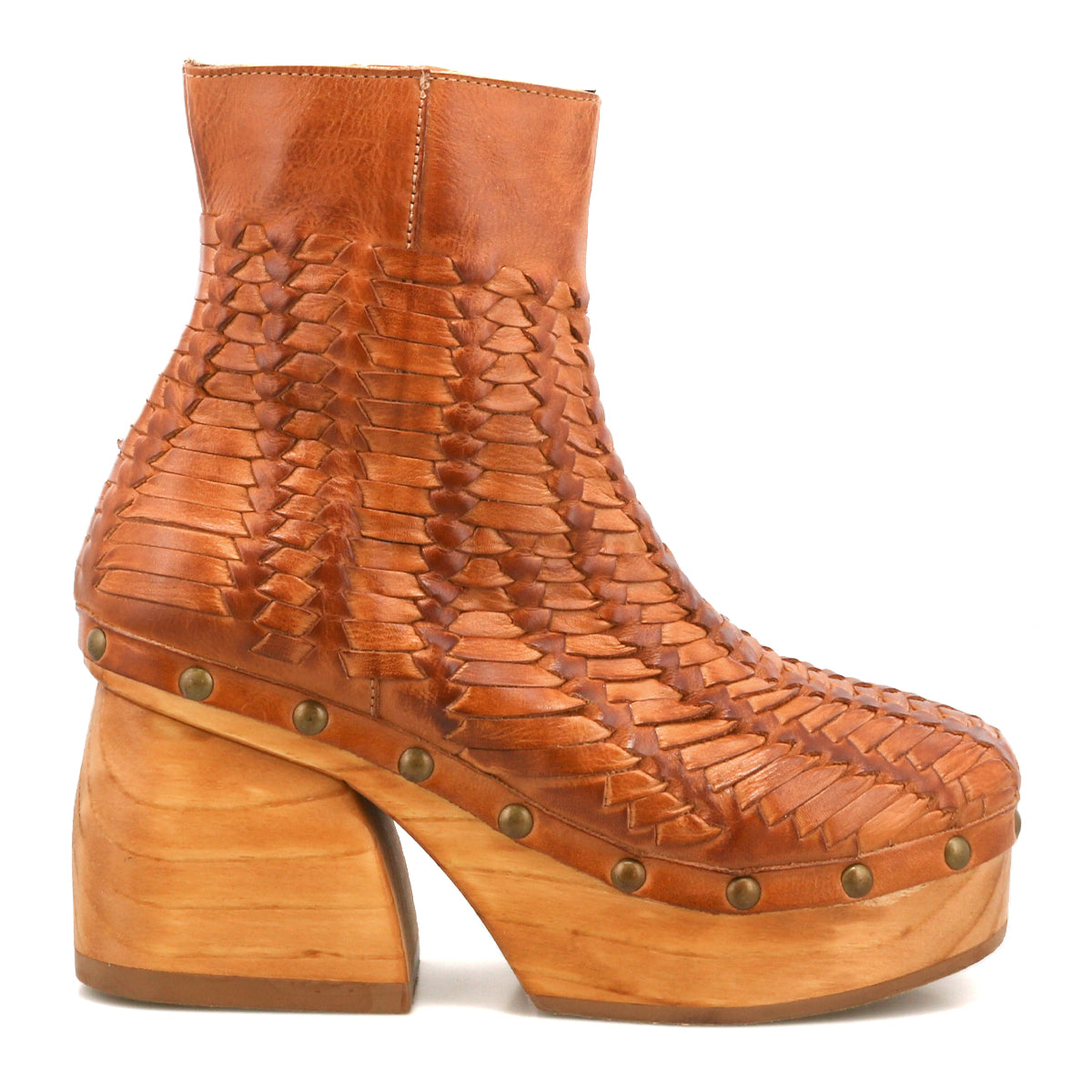 The Ellasphin by Bed Stu is a brown leather ankle boot featuring woven detailing, a thick wooden heel, platform sole, and brass studs—artisan footwear with timeless sculptural style.