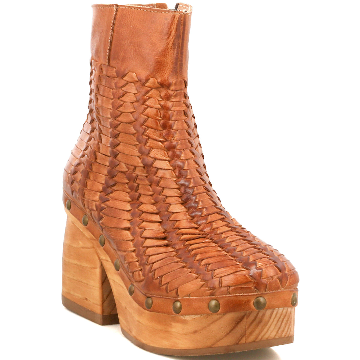 The Ellasphin by Bed Stu is a brown woven leather boot with a high wooden platform heel and metal studs—an artisan footwear piece fusing timeless craftsmanship and modern sculptural style.