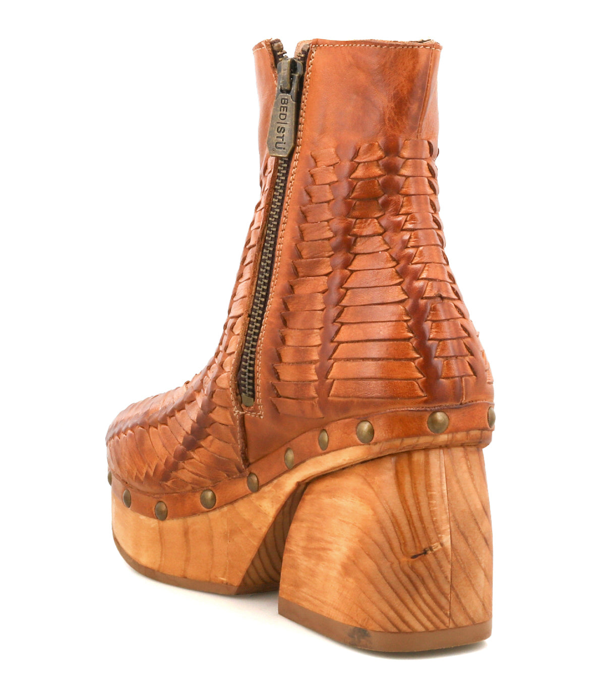 The Ellasphin ankle boot by Bed Stu features tan leather, a woven pattern, side zipper, wooden block heel, and metal rivets for artisan style and sculptural flair.