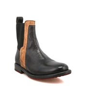 The Ethic by Bed Stu is a black vegetable-tanned leather Chelsea boot featuring brown accents, elastic side panels, a back pull tab, a low heel, and a bold red outsole.