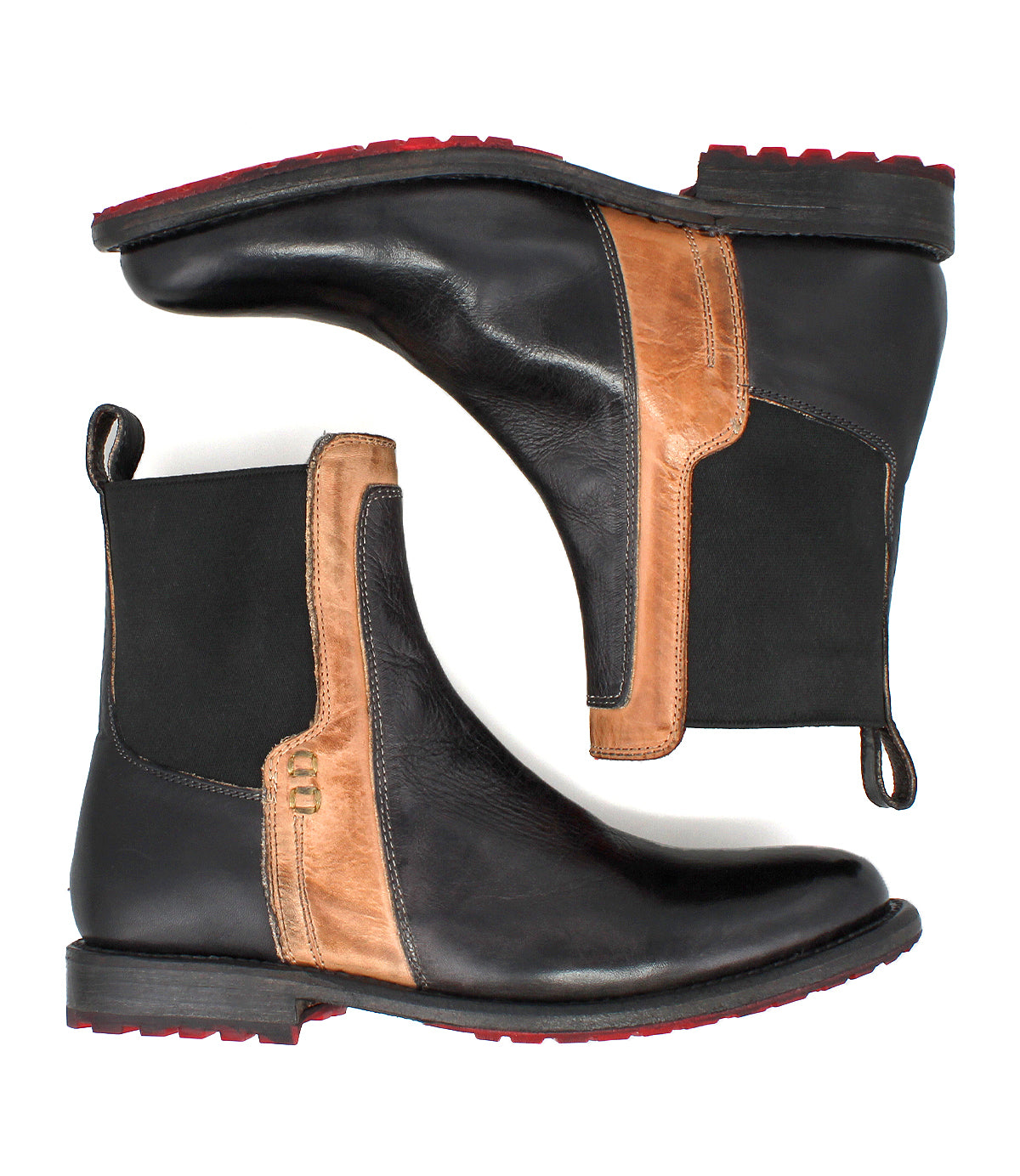 The Bed Stu Ethic boots are black Chelsea boots with brown accents, made from vegetable-tanned leather. They feature black elastic side panels, red Vibram soles, and pull tabs at the back, shown side by side.