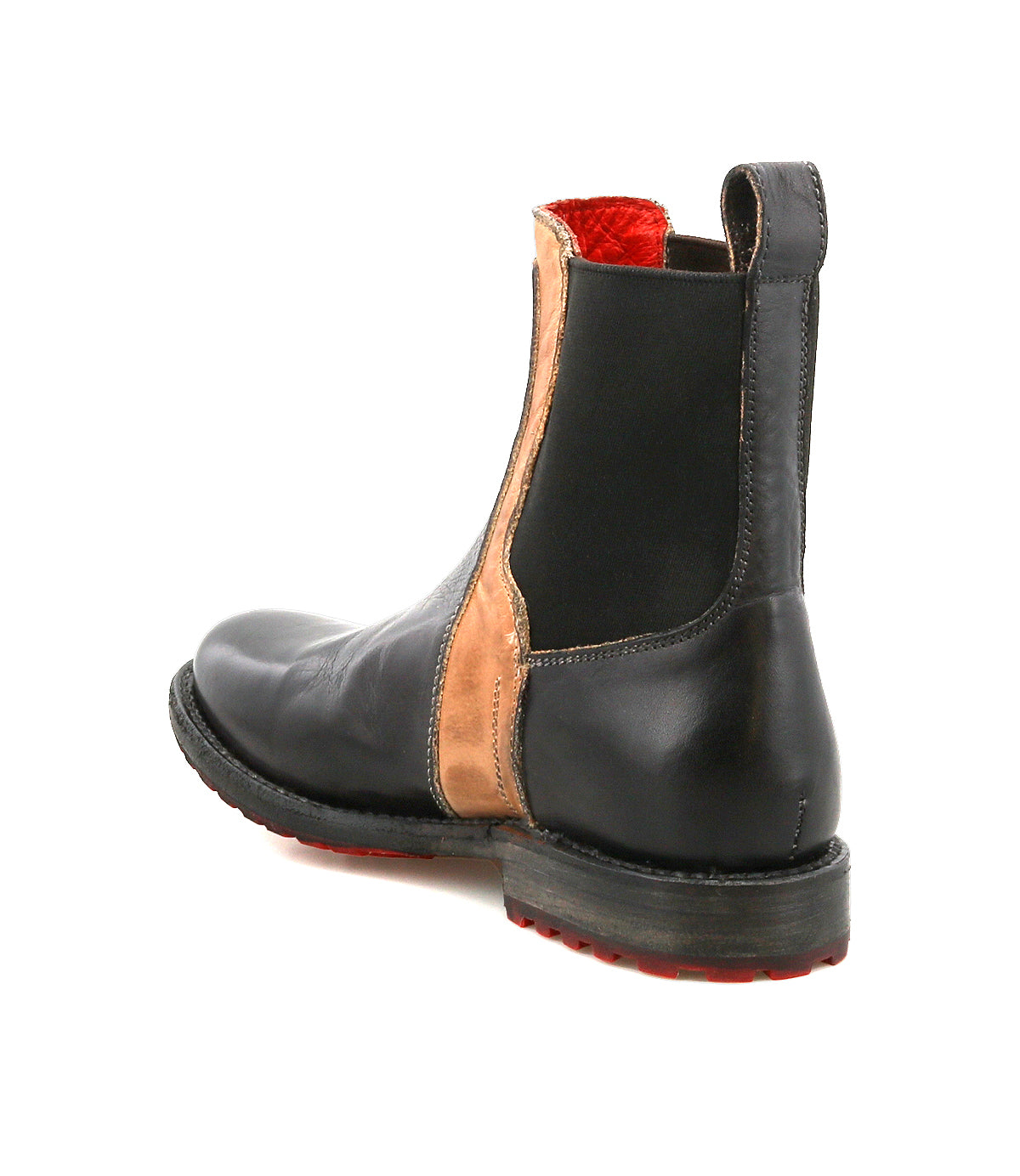 The Bed Stu Ethic is a black leather Chelsea boot featuring tan vegetable-tanned leather side panels, a red interior lining, and a black sole with red tread, displayed from the rear angle.