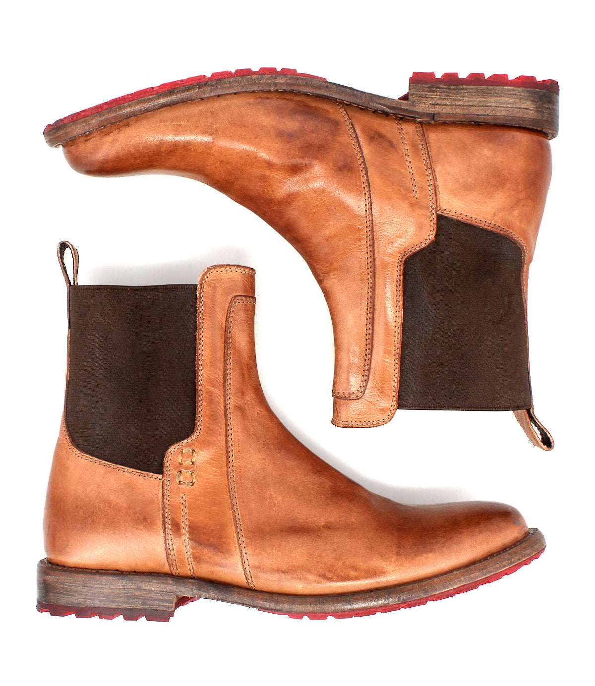 The Bed Stu Ethic boots are a pair of tan vegetable-tanned leather Chelsea boots with dark brown elastic side panels and red Vibram soles, displayed side by side on a white background.