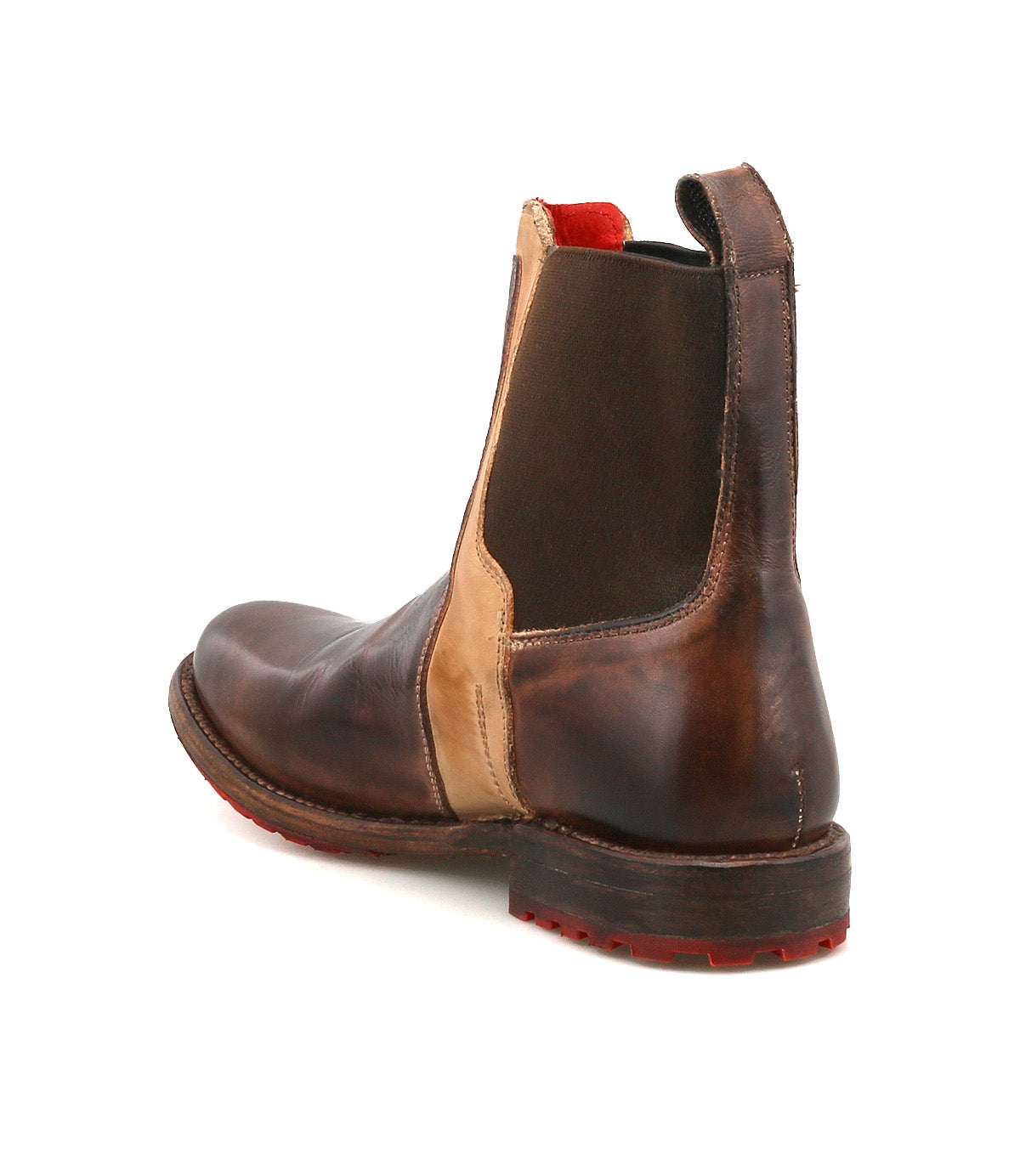 The Bed Stu Ethic is a brown and tan Chelsea boot made from vegetable-tanned leather, featuring elastic side panels, a back pull tab, and a red-treaded Vibram sole. Shown angled on a white background.