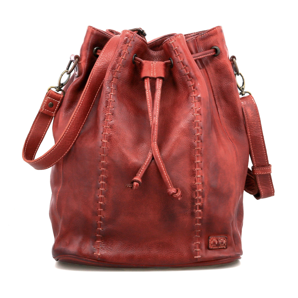 The Bed Stu Eve is a red leather bucket bag with a drawstring cinch, visible side stitching, and a shoulder strap that can also be worn crossbody.