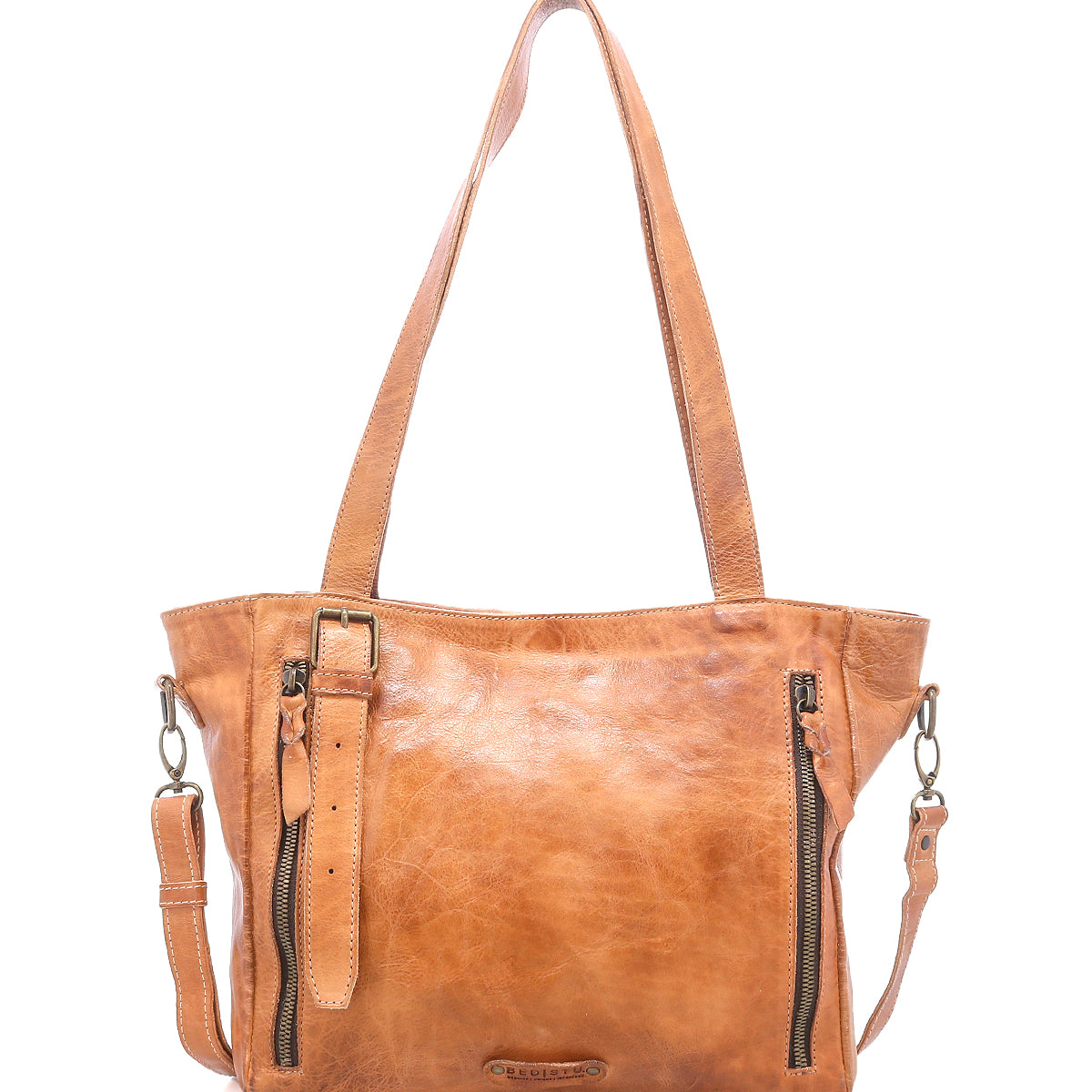 The Bed Stu Explicit LTC is a tan, seasoned leather tote with two shoulder straps, a detachable crossbody strap, front zippers, and a small buckle strap—perfect for adding rustic appeal to your everyday bag collection.