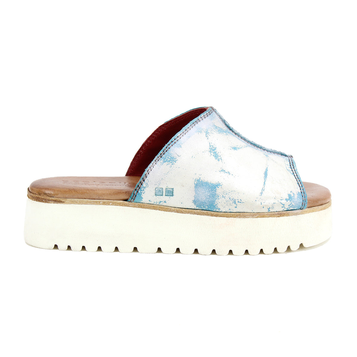 The Bed Stu Fairlee II, a white flatform slide sandal with blue accents, a thick sole, and a leather-lined footbed, is showcased on a white background.