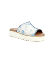 The Fairlee II by Bed Stu is an eco-friendly sandal with a blue and white marbled strap, open toe, and thick white platform sole set against a pristine white background.