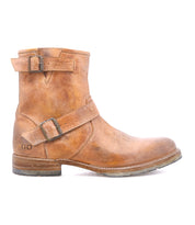 The Bed Stu Fellow is a brown moto-inspired ankle boot featuring two adjustable straps with metal buckles, displayed in profile on a white background.