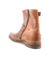The Bed Stu Fellow is a rugged men's Goodyear welted leather boot with a side zipper, shown in worn and scuffed brown leather against a white background.