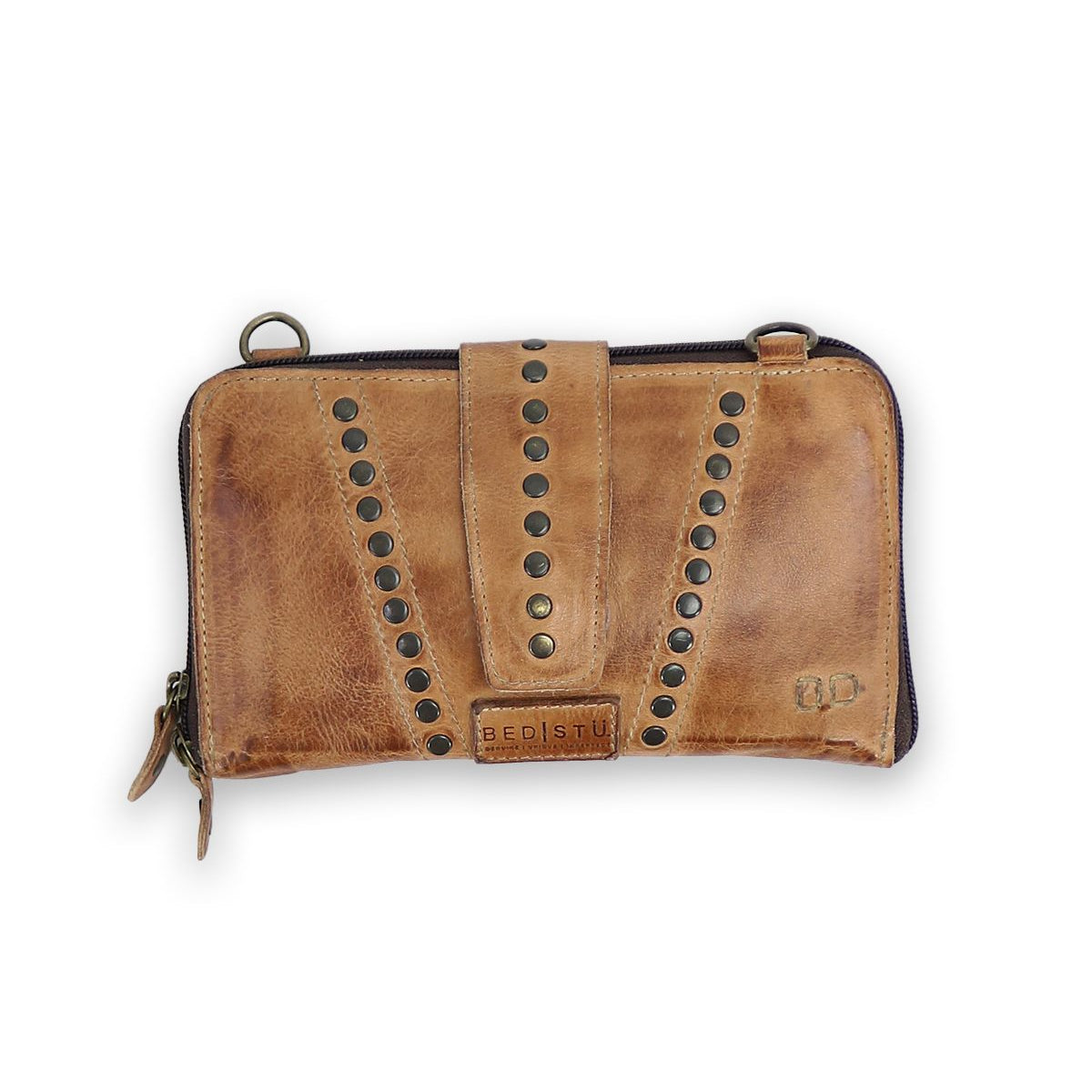 A brown leather wallet called "Flee" with metal rivets and a strap closure, featuring a secure zip closure. The brand label "Bed Stu" is visible.