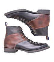 A pair of Bed Stu Frenzy brown and black leather lace-up boots is displayed in a side view, placed horizontally with soles facing outward. Crafted with Goodyear welt construction, these men's hiking boots offer durability and style, making them perfect for outdoor adventures.