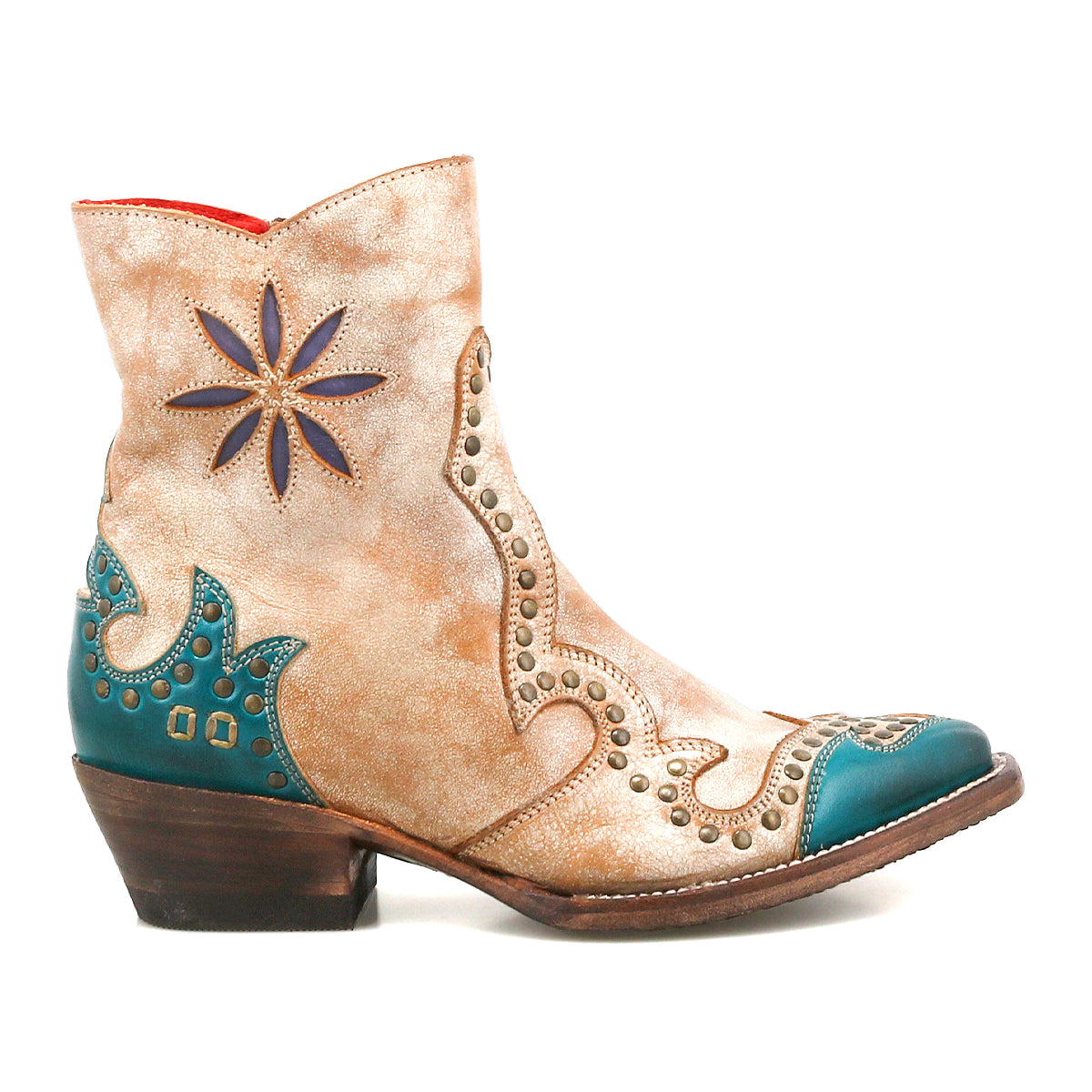 The Bed Stu Frio is a tan and teal Western bootie featuring decorative stitching, floral cutouts, brass studs, star-shaped accents, and a low stacked heel.