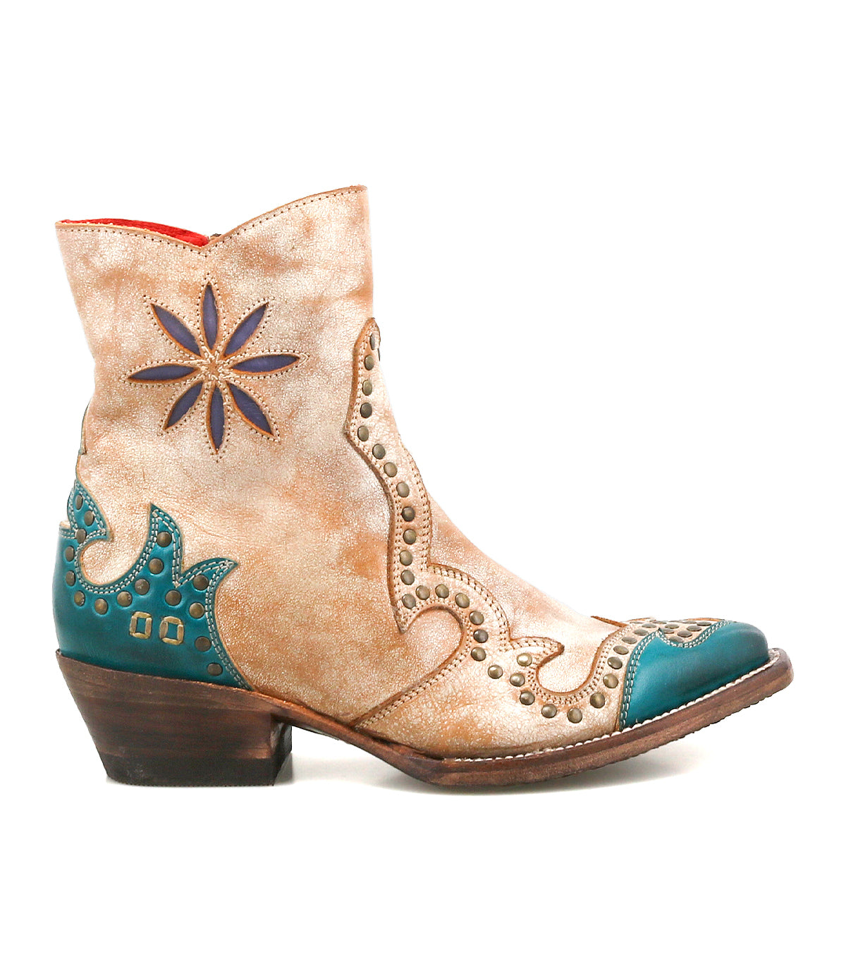 The Bed Stu Frio is a tan and teal Western bootie featuring decorative stitching, floral cutouts, brass studs, star-shaped accents, and a low stacked heel.