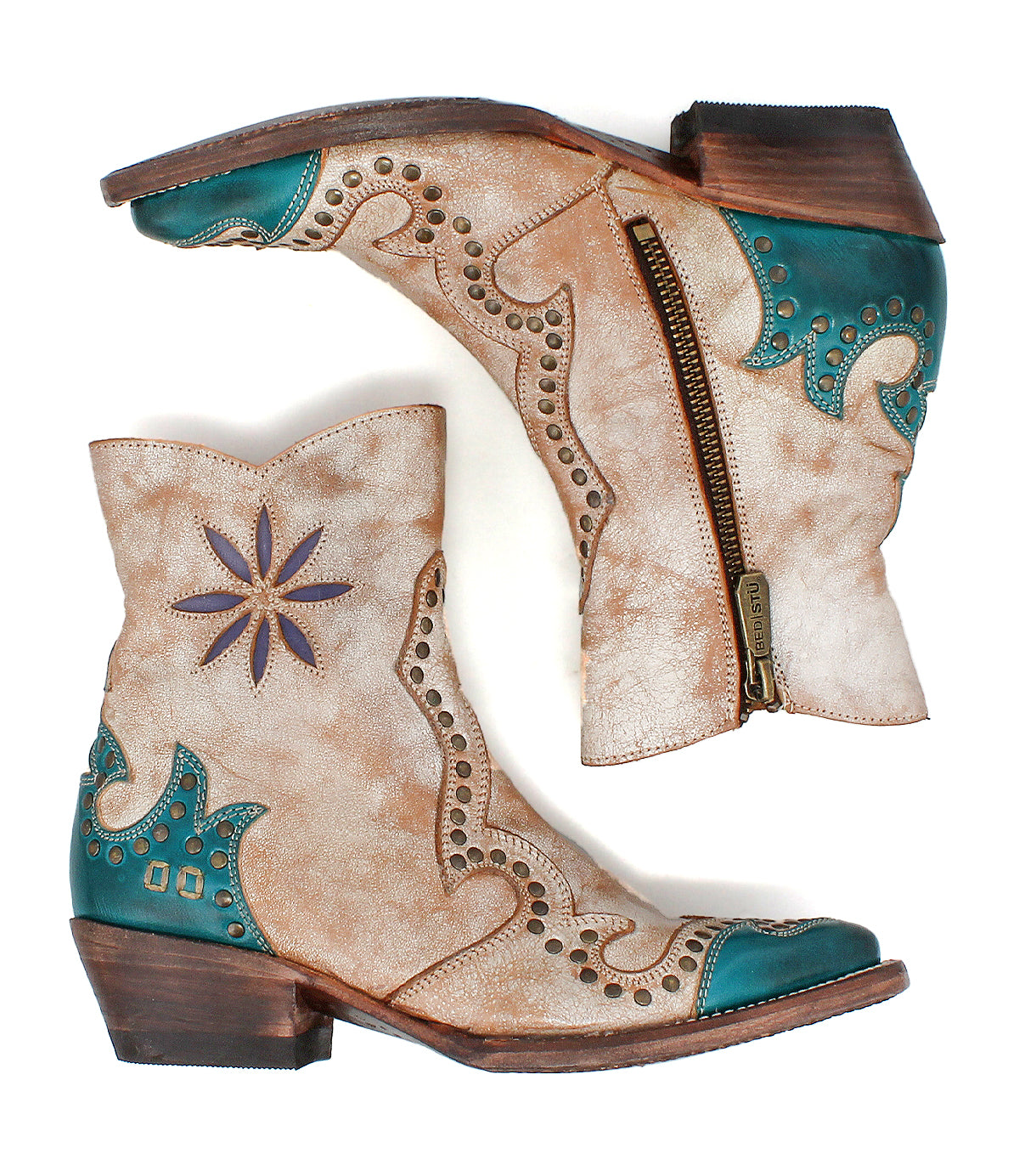 The Bed Stu Frio is an ankle-height, distressed tan leather Western bootie with turquoise accents, floral cutouts, brass studs, decorative stitching, side zippers, and wooden heels—shown on a white background.