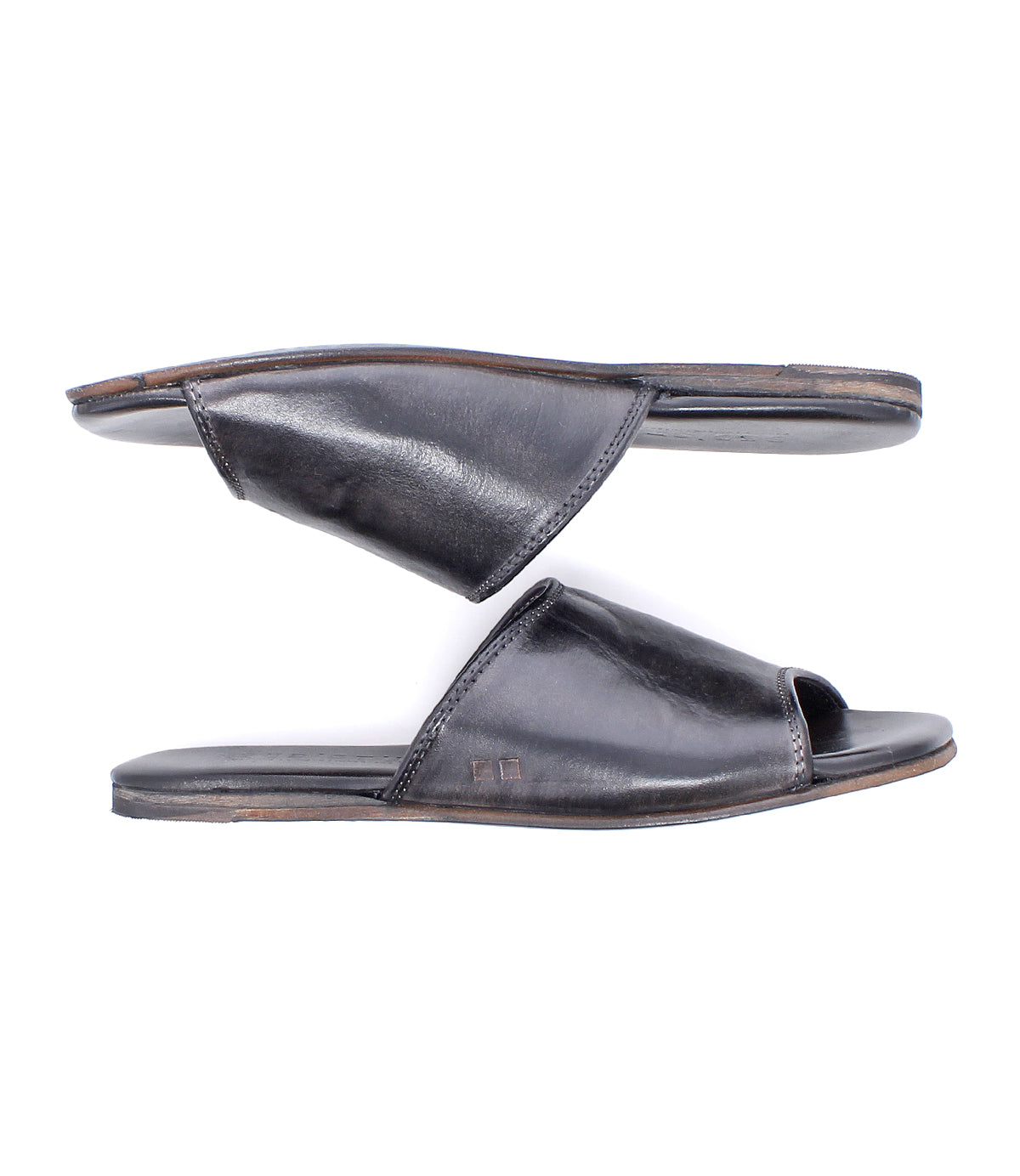 The Bed Stu Gailee is a pair of black leather slide open-toe sandals shown side view, with one sandal above the other on a white background. Designed for comfort, they feature a cushioned footbed.