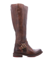 Bed|Stü Glaye Wide Calf brown leather equestrian knee-high boot with a side zipper and a buckled ankle strap.
